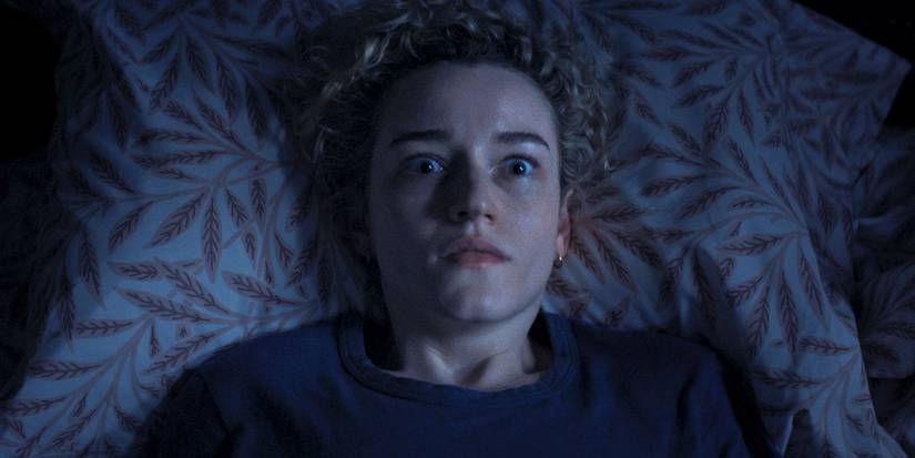 Julia Garner lying in bed in Weapons.
