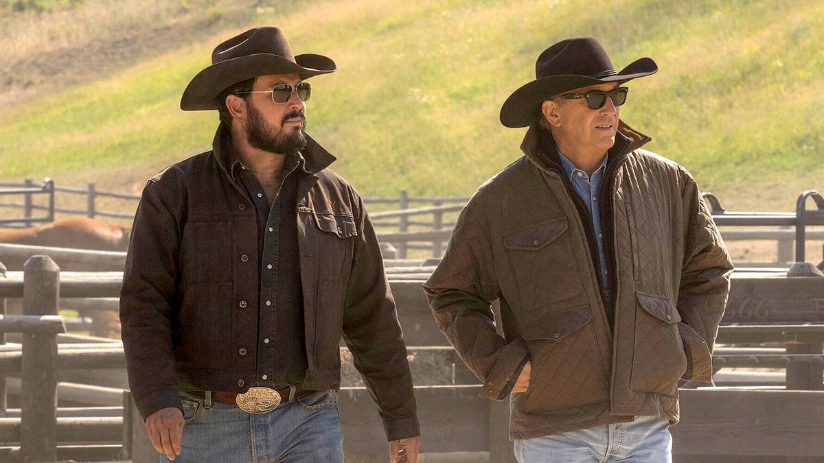 Cole Hauser as Rip Wheeler and Kevin Costner as John Dutton in Yellowstone walking on the ranch.