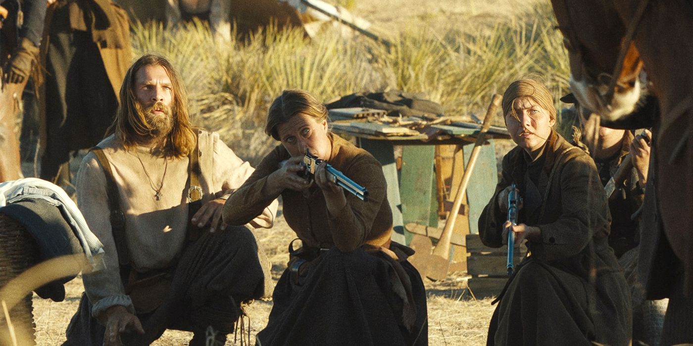 Marc Rissmann kneeling next to women with rifles ready in 1883
