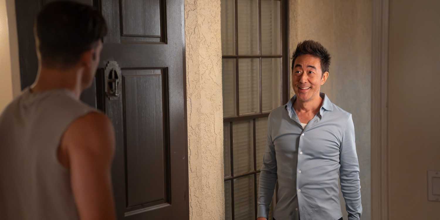 Chimney Han standing in Eddie's doorway smiling in 9-1-1 Season 9