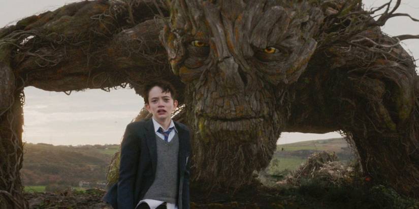 Conor O'Malley (Lewis MacDougall) with a monster behind him in 'A Monster Calls'