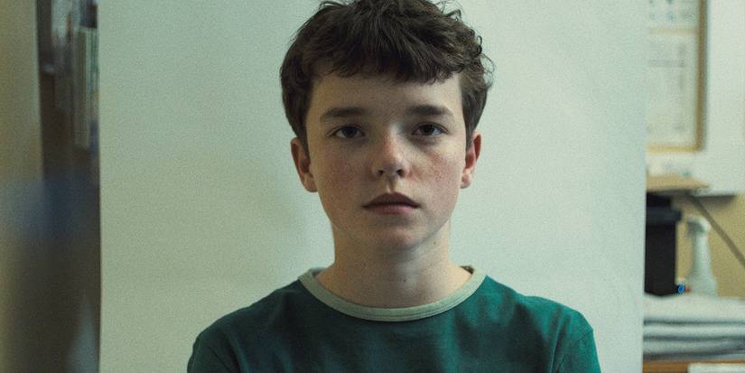 Owen Cooper staring ahead with a vacant expression in Adolescence.