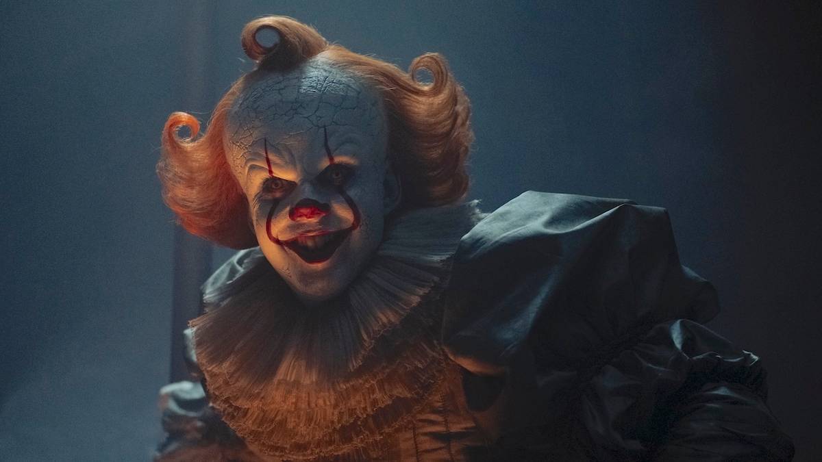 Bill Skarsgard as Pennywise the Dancing Clown smiling in IT: Welcome to Derry
