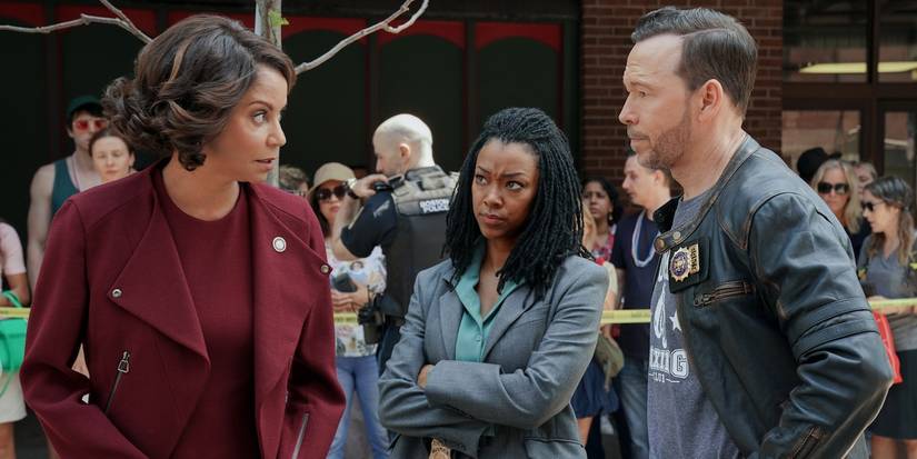 Sonequa Martin-Green as Lena and Donnie Wahlberg as Danny talking to Gloria Reuben in Boston Blue