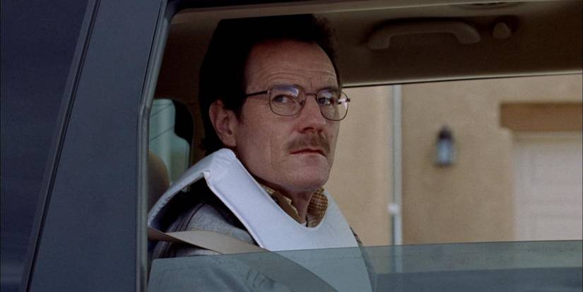 Walter White (Bryan Cranston) sitting in a van with a vest on in the pilot episode of 'Breaking Bad'.