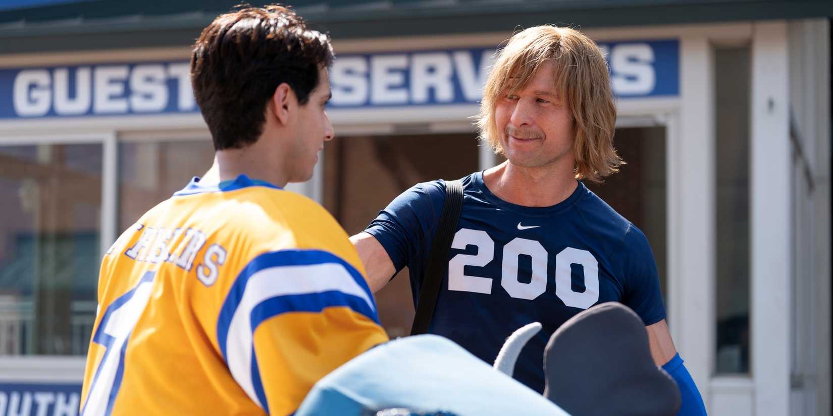 Frankie A. Rodriguez as Danny in his catfish costume without the head with Glen Powell as Chad in Chad Powers