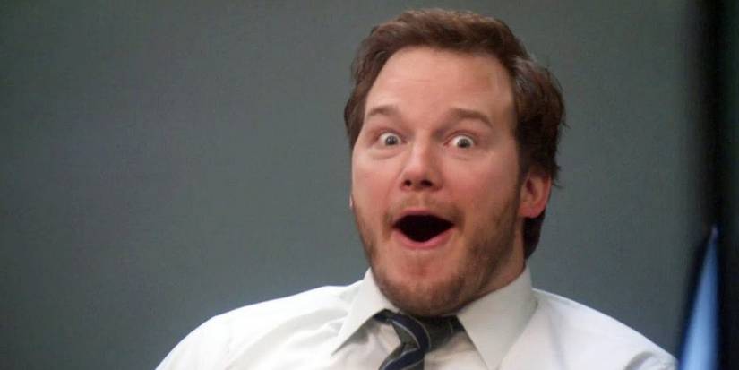 Andy looks at the camera with an open mouth in Parks and Recreation.