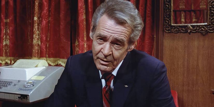 A man looking intently at someone off-camera in Executive Action