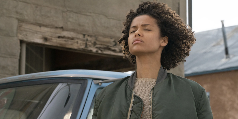 A woman closes her eyes next to a car in 'Fast Car'