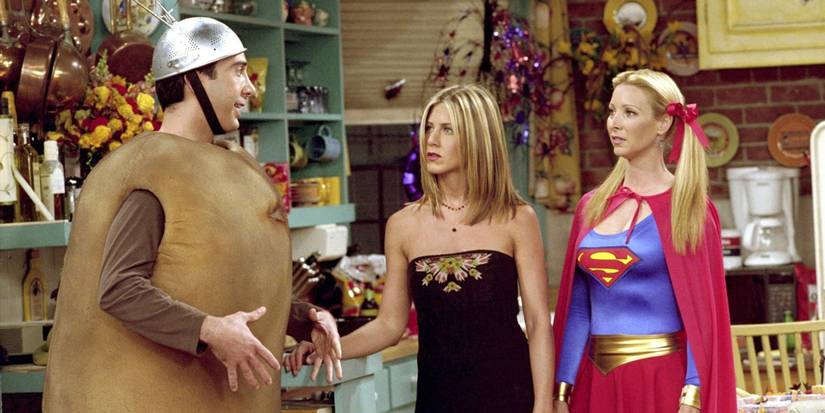 Ross, Rachel, and Phoebe in Halloween costumes talking inside the apartment in Friends.