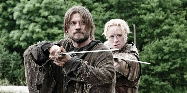 Jaime Lannister (Nikolaj Coster-Waldau) and Brienne of Tarth (Gwendoline Christie) holding swords in 'Game of Thrones' Season 3