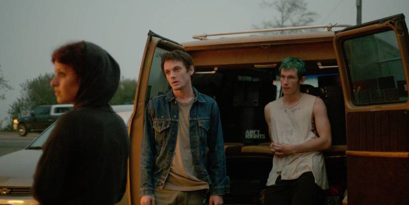 Two young men standing outside an open van in Green Room
