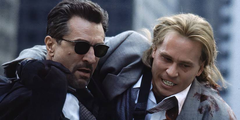 Robert De Niro helping a wounded Val Kilmer down the road during a bank heist gone wrong in Heat