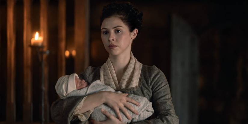 Hermione Corfield as Julia Beachamp holding a baby in Outlander: Blood of My Blood.