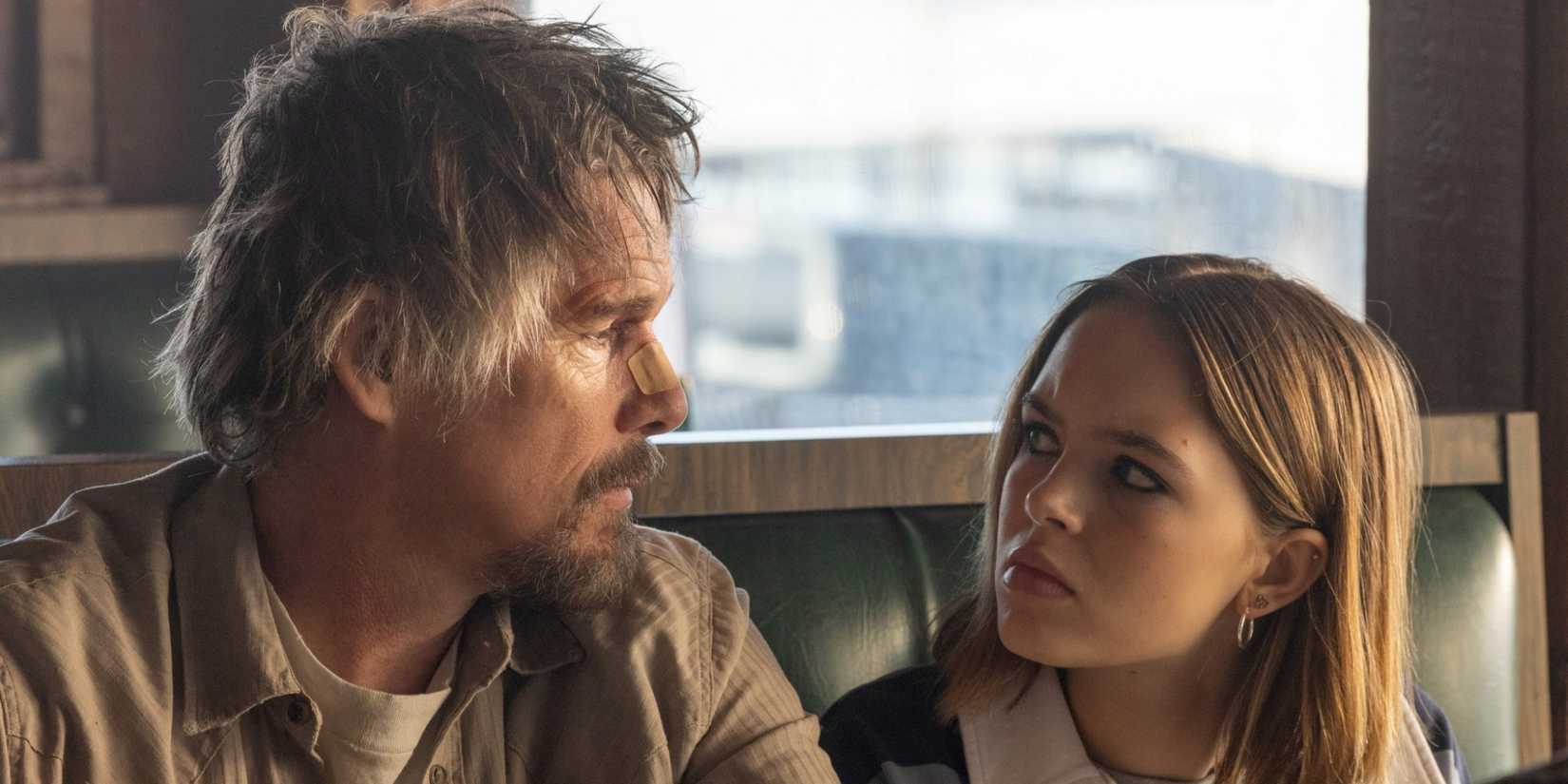 Ethan Hawke as Lee Baybon sitting in a diner booth with Ryan Kiera Armstrong as Francis in The Lowdown