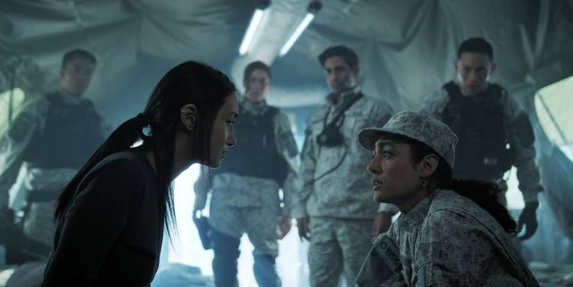 Mitsuki kneels down to talk with Aneesha in Invasion Season 3, Episode 9.