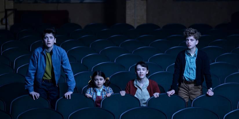 Phil, Susie, Lilly, and Terry in a movie theater in 'It: Welcome to Derry'