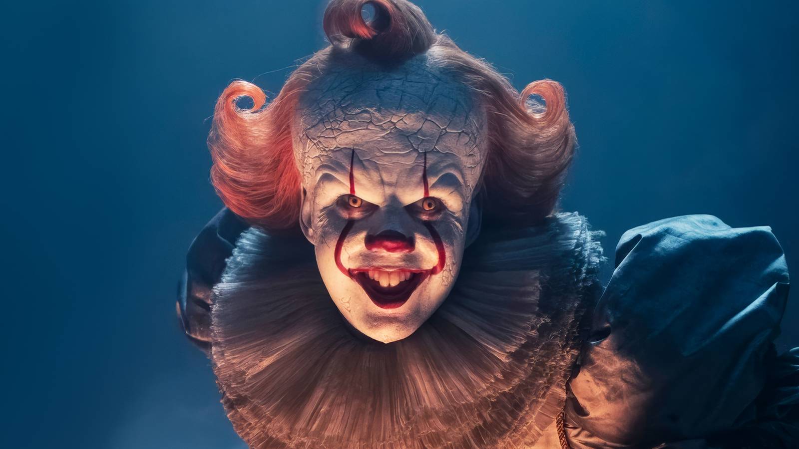 Bill Skarsgard as Pennywise bending over and smiling for the camera in It: Welcome to Derry