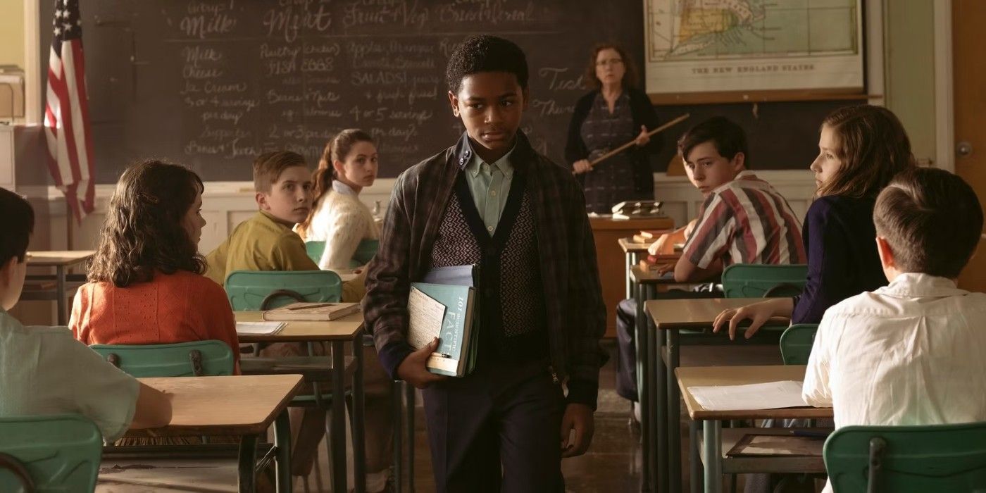 Blake Cameron James as Will Hanlon walking to his desk at school in IT: Welcome to Derry