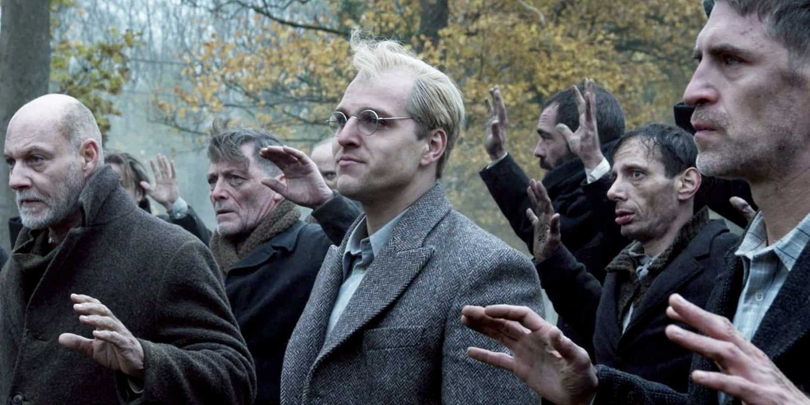 Jonas Dassler as Dietrich Bonhoeffer with a group of other men in Bonhoeffer: Pastor. Spy. Assassin.