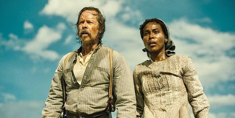 Guy Pearce and DeWanda Wise look on against a blue sky in Killing Faith