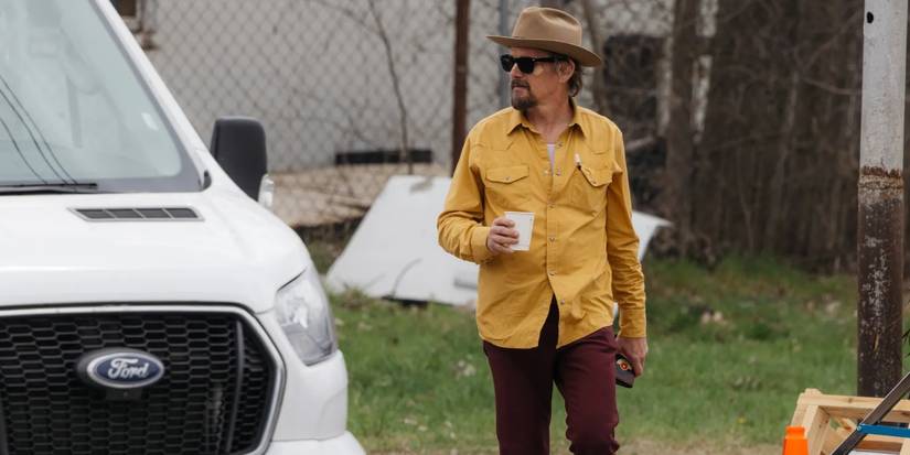 Lee Raybon (Ethan Hawke) with sunglasses and hat, holding coffee cup, in 'The Lowdown'