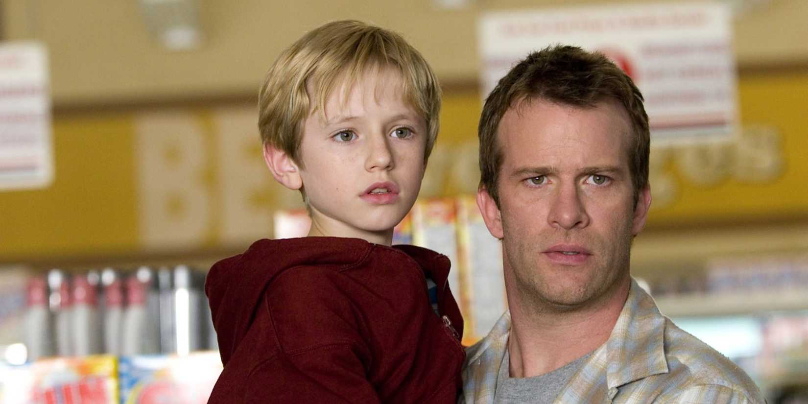 Thomas Jane holds his son in a supermarket in The Mist