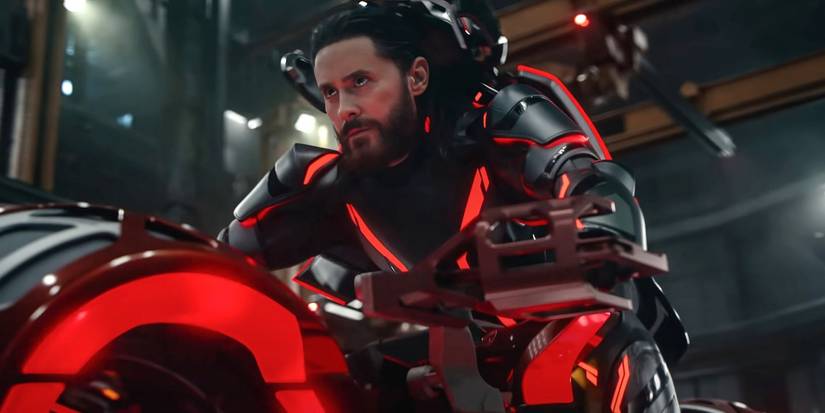 Jared Leto, without his helmet, rides a neon bike in Tron: Ares