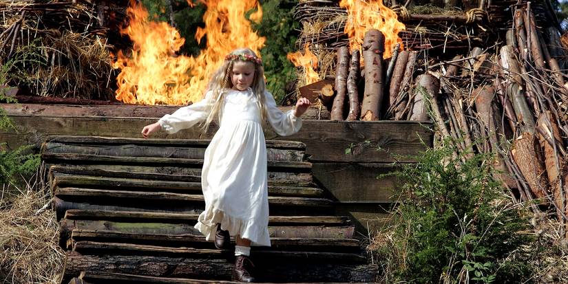 A little girl walking down steps in front of a fire in The Wicker Man 2006
