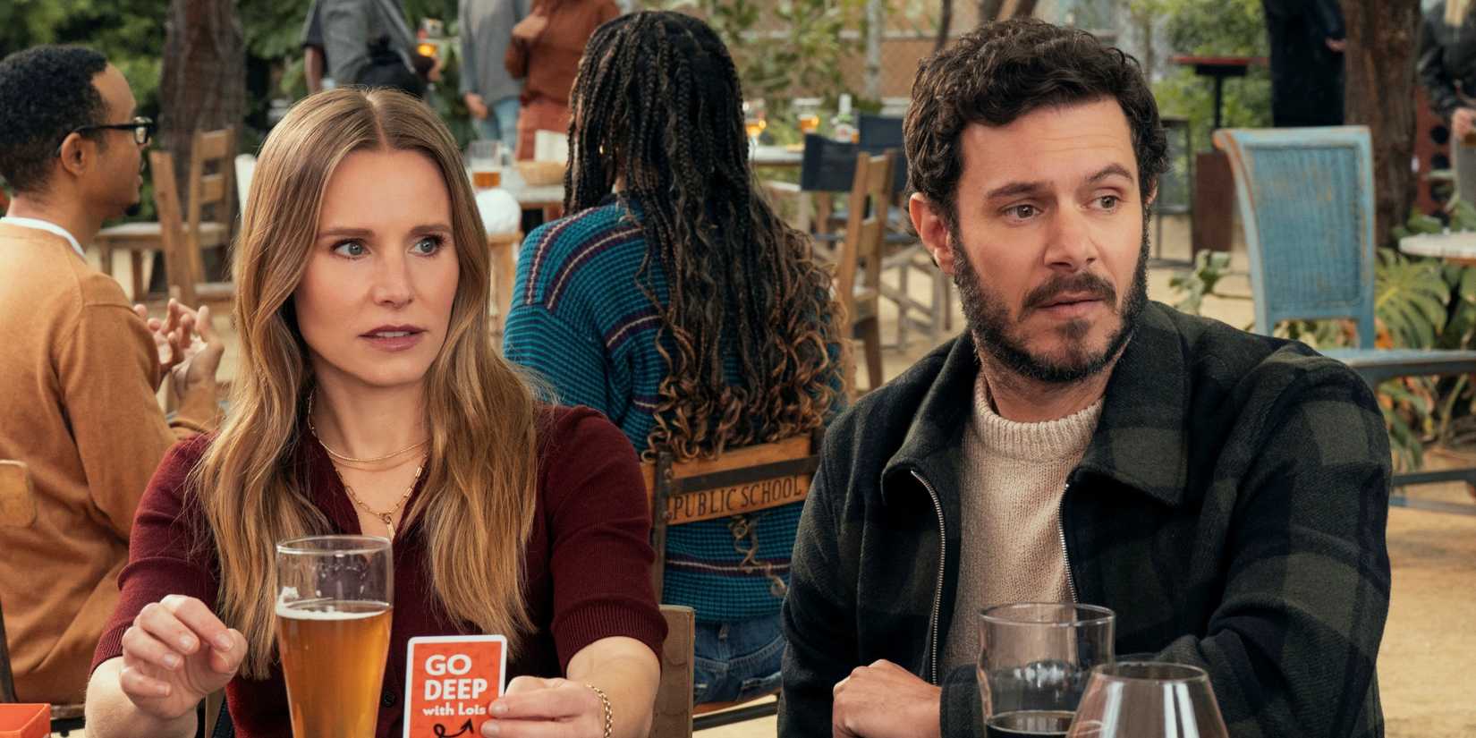 Kristen Bell as Joanne sitting next to Adam Brody as Noah at a restaurant in Nobody Wants This Season 2