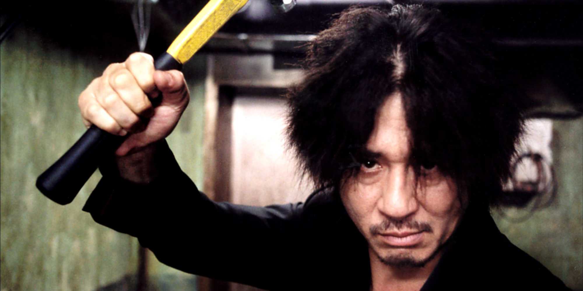 Oh Dae-su (Choi Min-sik) holding a hammer at the camera in Oldboy