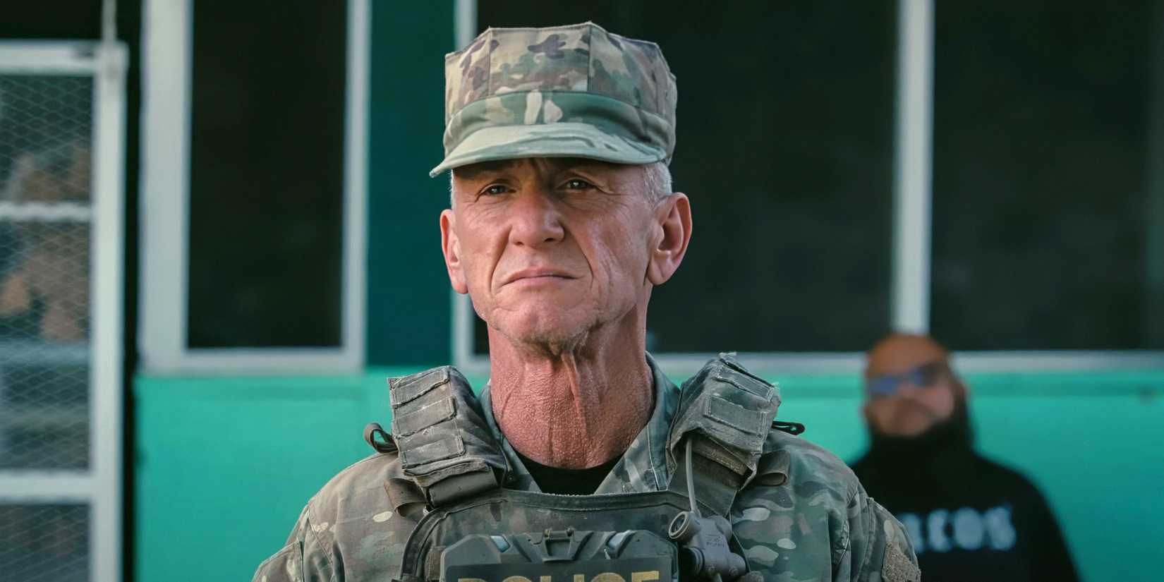 Sean Penn standing in uniform at attention in One Battle After Another