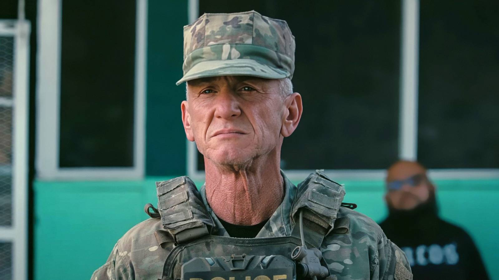 Sean Penn standing in uniform at attention in One Battle After Another