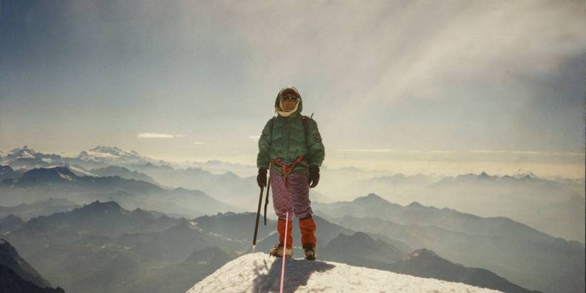 Pasang posing for a photo at the top of Mount Everest, as featured in the movie Pasang: In the shadow of Everest