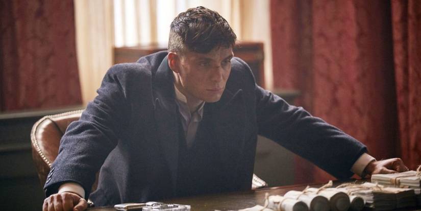 Cillian Murphy as Tommy Shelby leaning on a desk in Peaky Blinders Season 3, Episode 6.