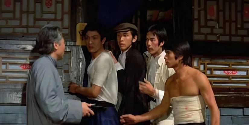 Five men are talking in The Savage Five.