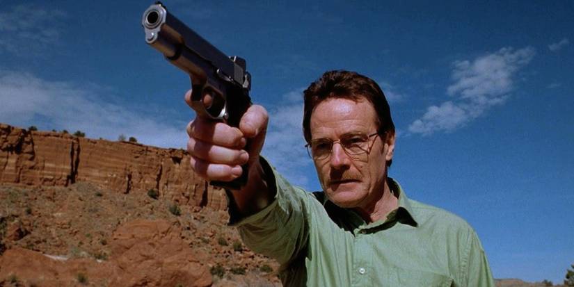 Bryan Cranston as Walter White pointing a gun in the Breaking Bad pilot.