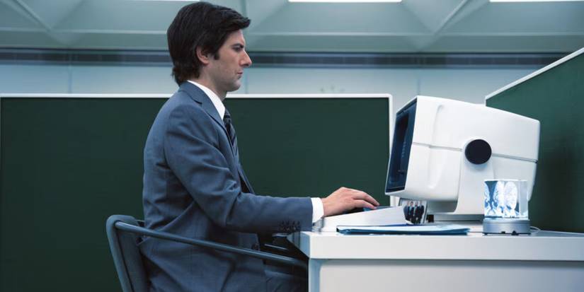Adam Scott as Mark works on his computer in the pilot of 'Severance.'