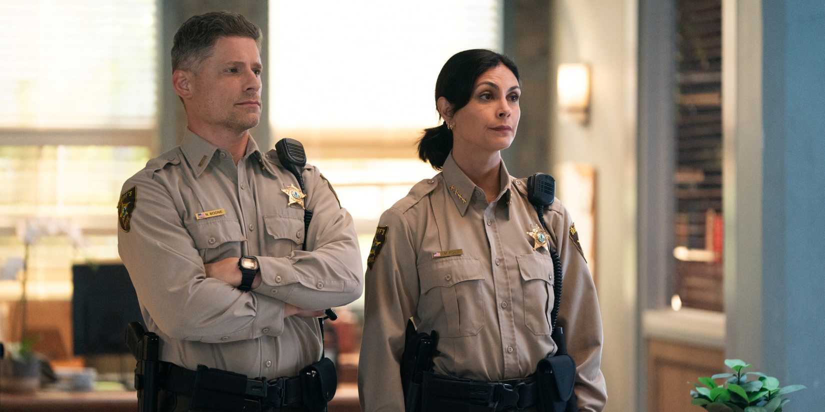 Morena Baccarin as Sheriff Mickey Fox standing next to Matt Lauria as Boone in Sheriff Country