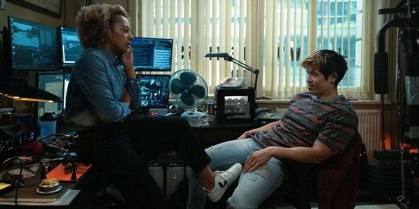 Louisa and Ho sitting in front of his computer equipment in 'Slow Horses'