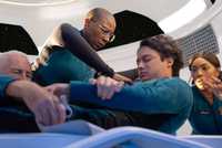 Hen Wilson and Athena Grant treating a patient in space in 9-1-1 Season 9