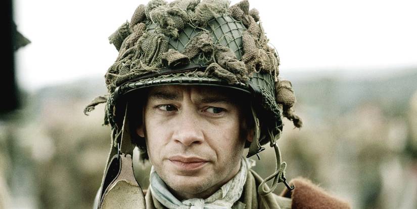Dexter Fletcher wearing a soldier helmet in 'Band of Brothers'.
