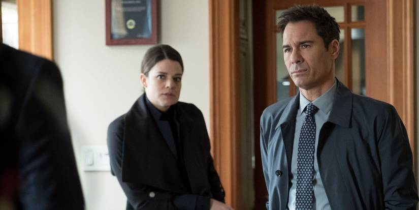 Kimberley Sustad and Eric McCormack talk to someone off camera in Travelers
