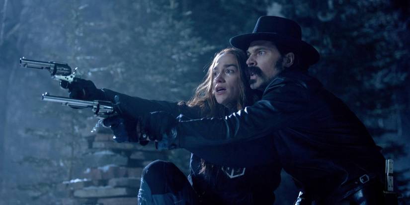 Wynonna Earp (Melanie Scrofano) and Doc Holliday (Tim Rozon) draw weapons on Wynonna Earp.