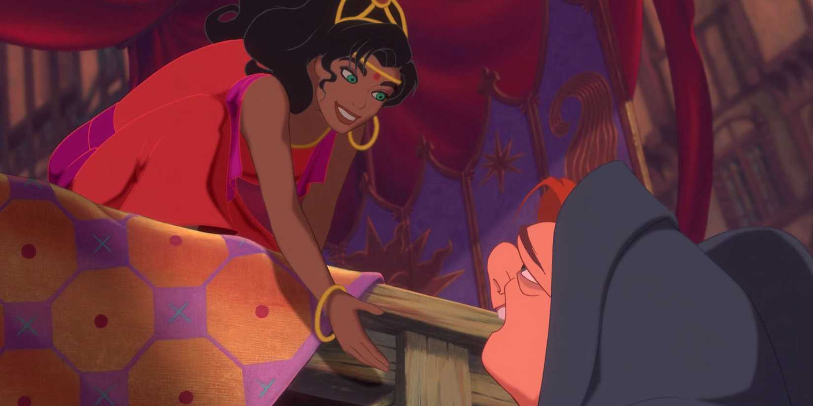 Esmeralda reaches down from a stage at a festival to Quasimodo in The Hunchback of Notre Dame.