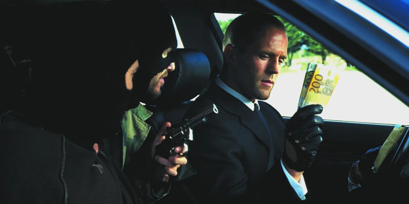 A well-dressed driver holds a cash while two masked robbers points a gun at him in a car