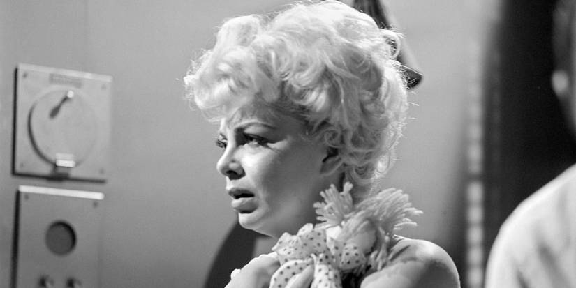 Barbara Nichols clutching a doll in 'The Twilight Zone' Season 2 Episode 17 "Twenty Two"