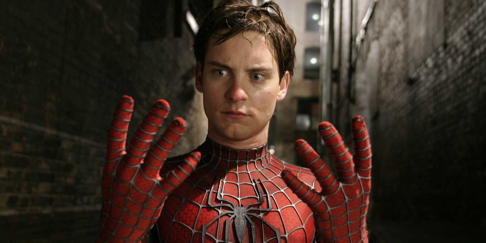 Tobey Maguire with his Spider-Man mask off looking at his hands in Spider-Man 2