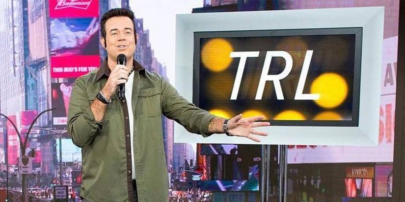 Carson Daly standing in front of a monitor in Total Request Live.