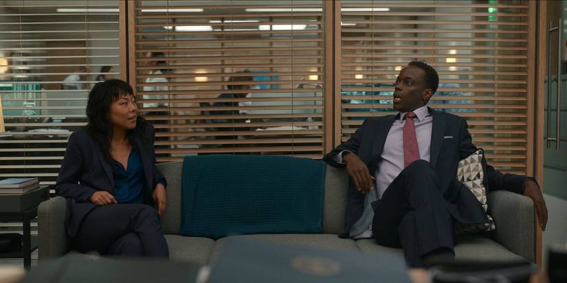 Ato Essandoh and Ali Ahn as Eidra and Stuart sitting in office in The Diplomat.